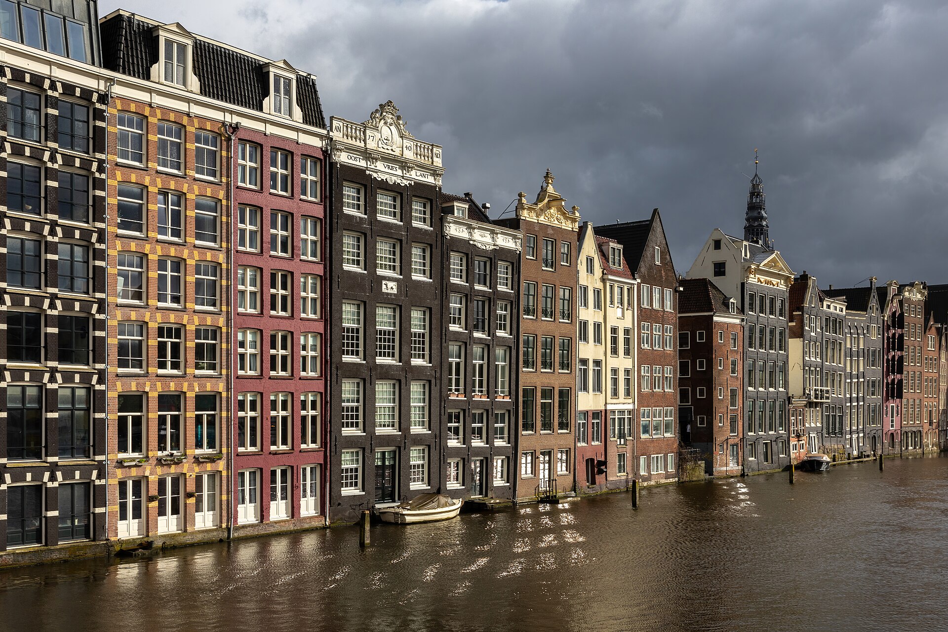 Colourful canal houses along the Damrak in Amsterdam